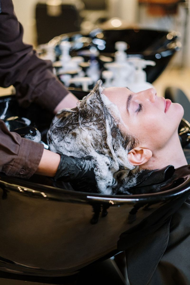 Client relaxing at the shampoo bowl during a deep treatment